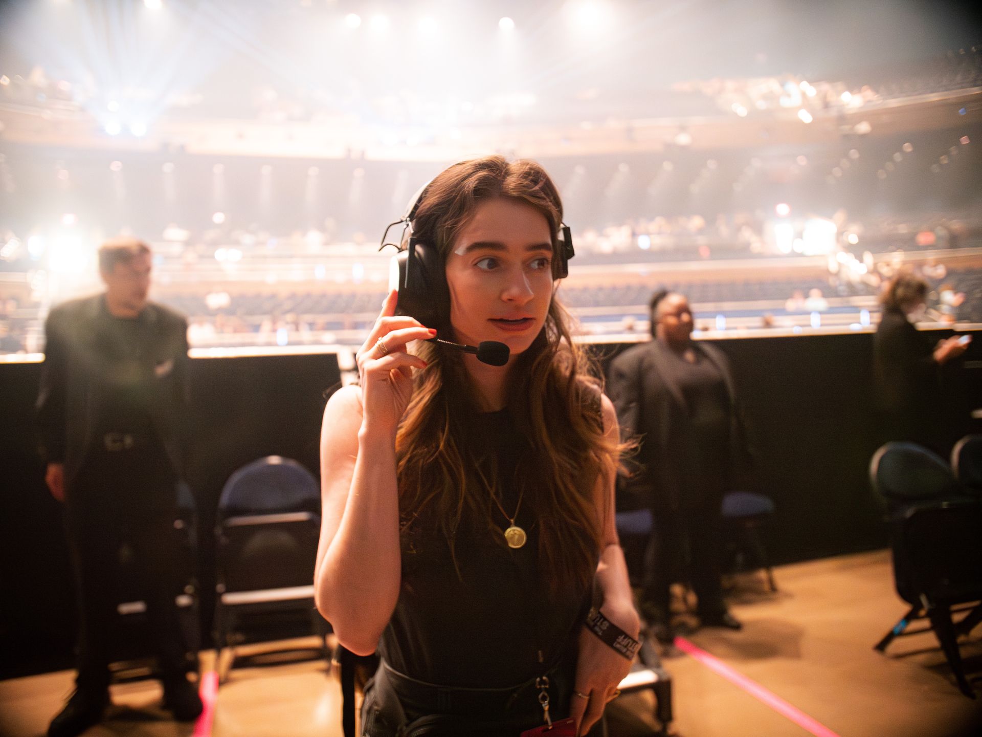 Beth Triffon wearing a headset while directing a live production.