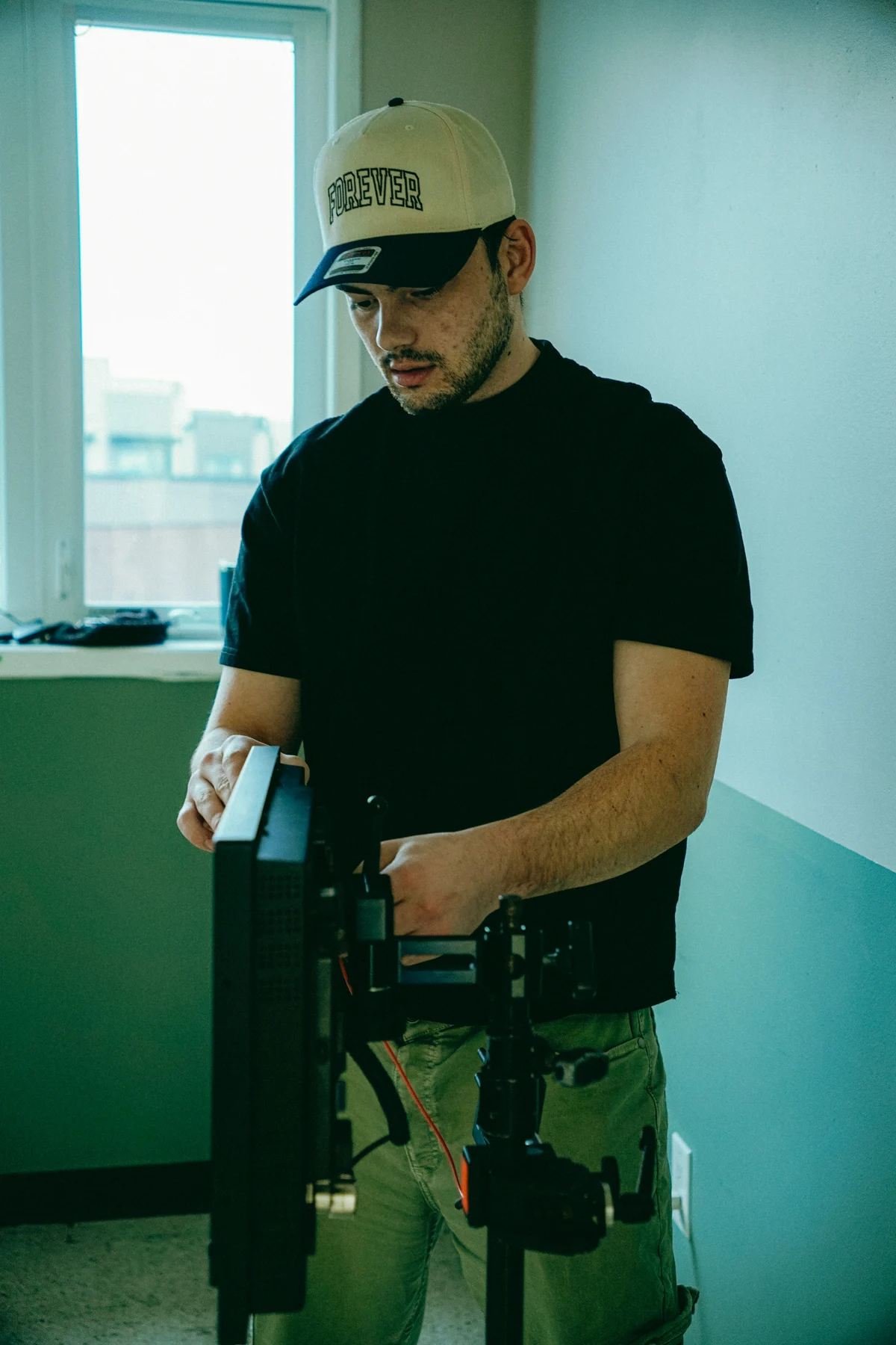 Nic adjusting a camera rig during a shoot.