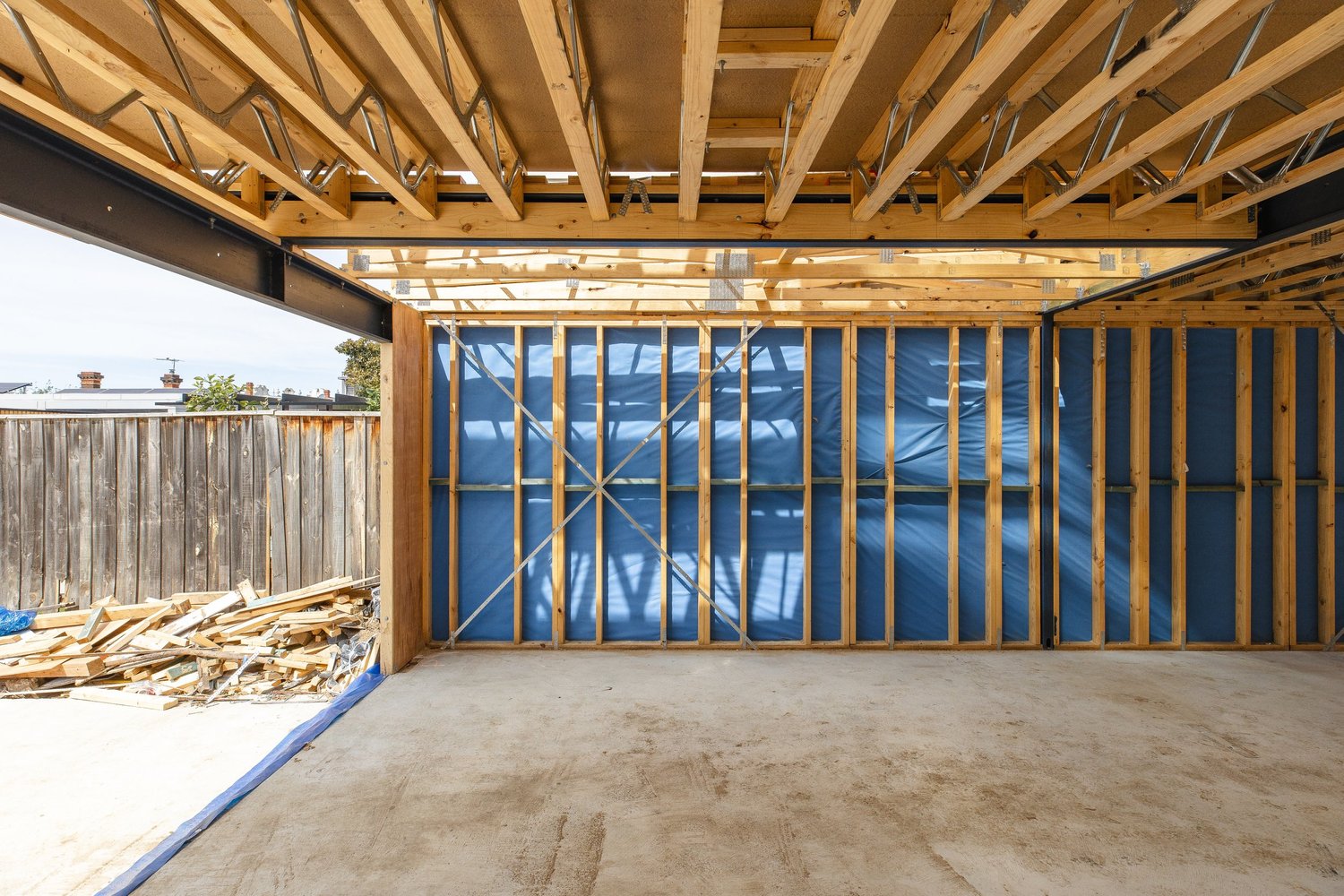 Timber framing and exposed roof beams inside a residential construction project, photographed by FLVR Creative.