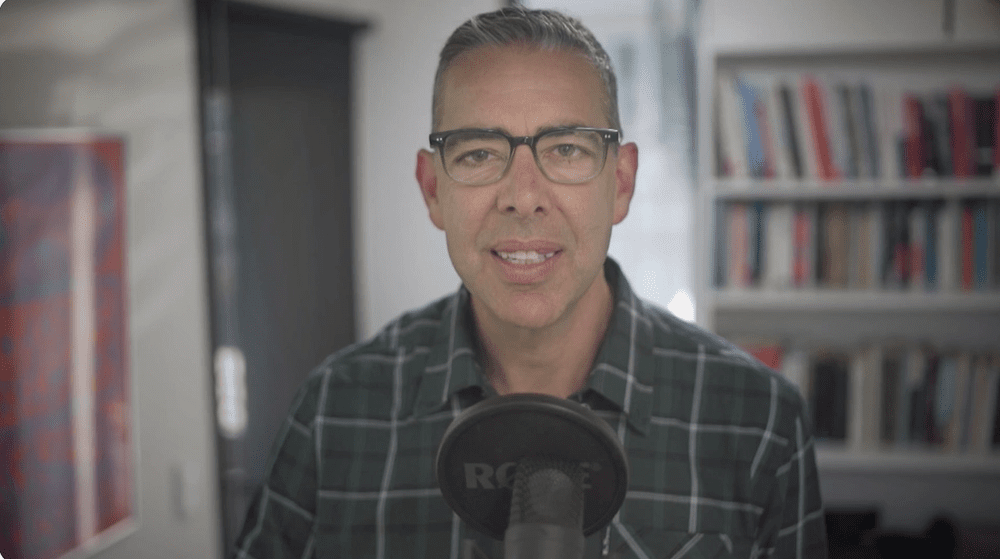 Ryan Spanger speaking into a microphone during an online call.