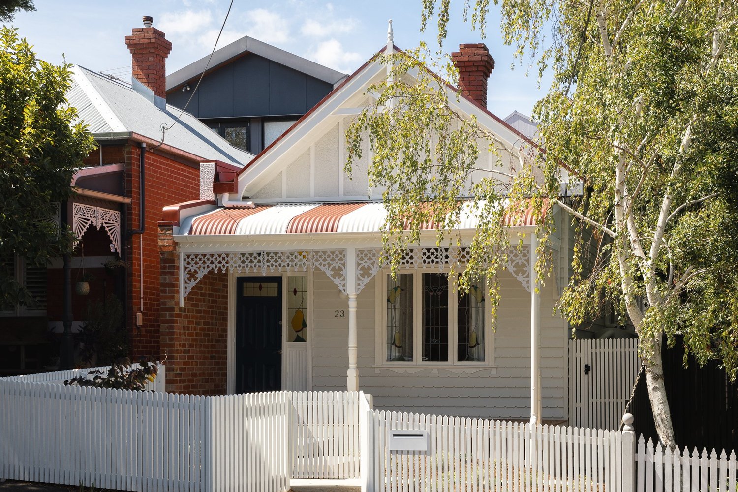A house with a restored weatherboard facade and contemporary extension, photographed by FLVR Creative.