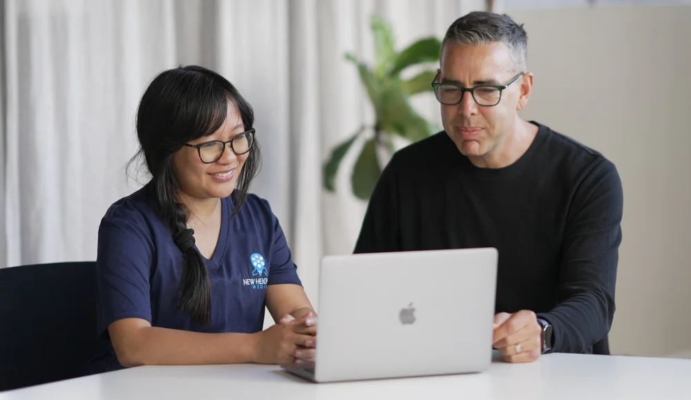 Ryan and Joyce working together at a laptop