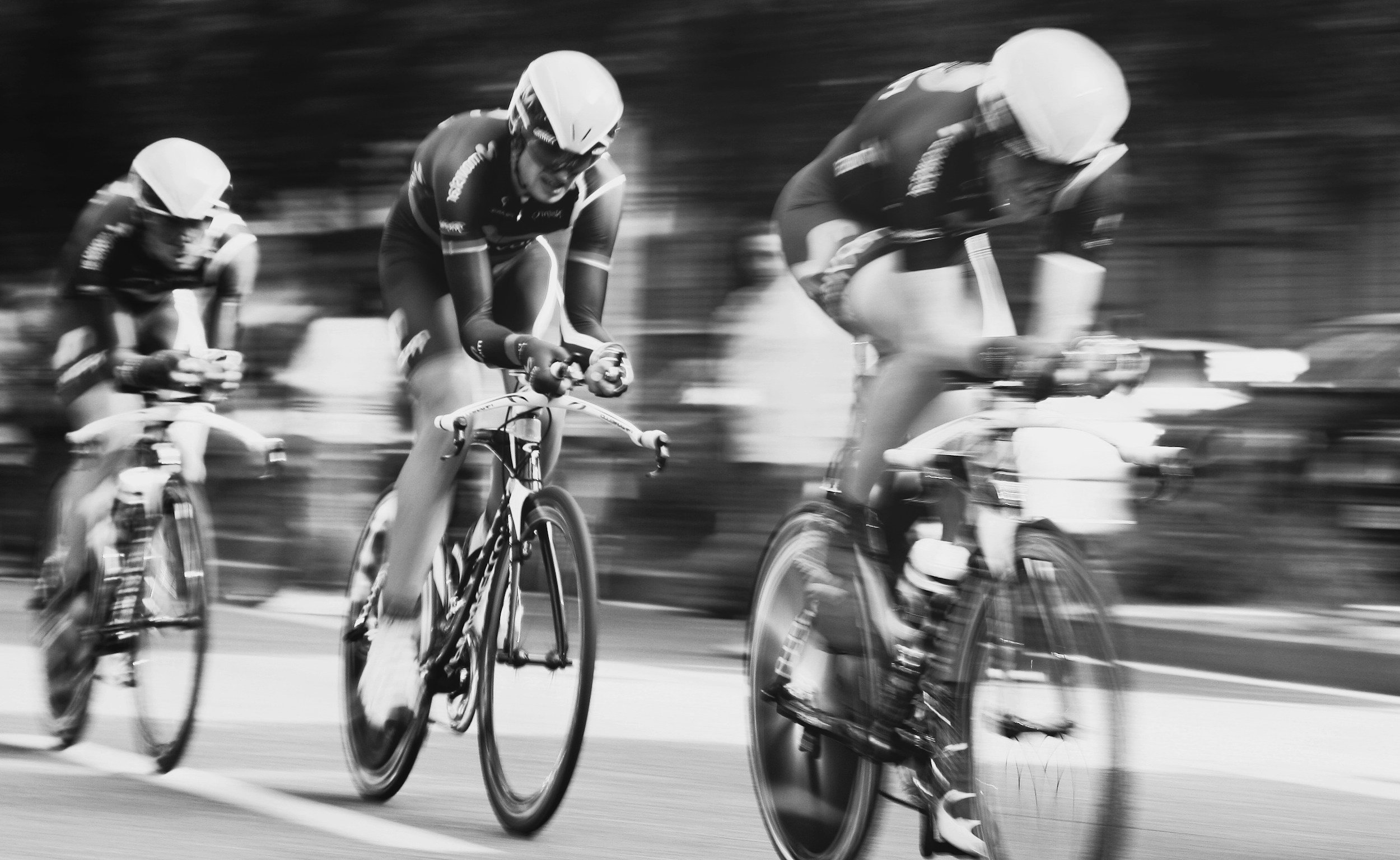 three cyclists racing each other