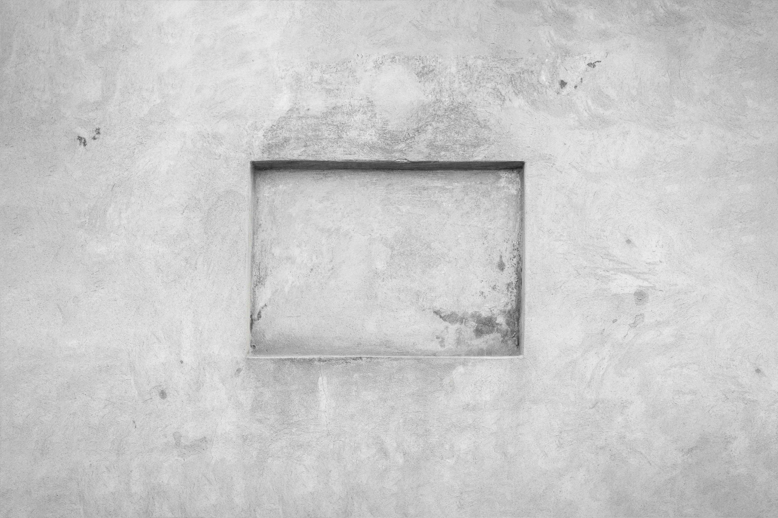 a square carved out of a cement wall